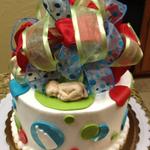 Butter cream cake with Fondant accents.  Fondant baby and fabric bow. 6 inch round cake serves 12