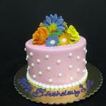 Buttercream frosting with gum paste flowers. 6 inch round cake serves 12