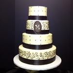 4 tier ivory buttercream cake . serves 128. fondant accents and fabric border